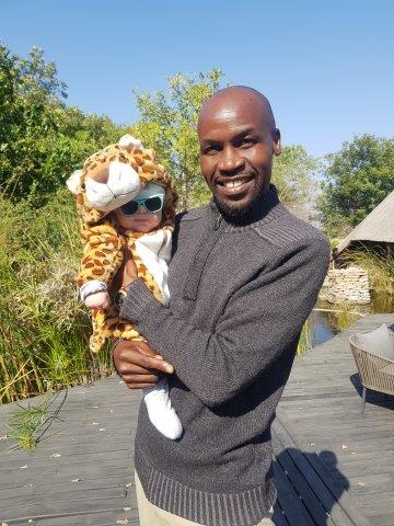 Chitwa staff member holding baby dressed as leopard cub