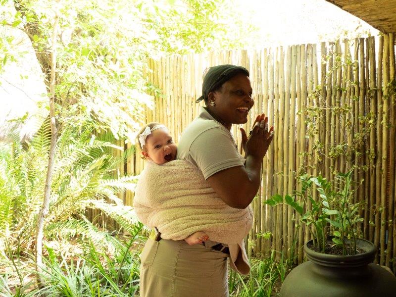 Lady with baby strapped to back at Singita