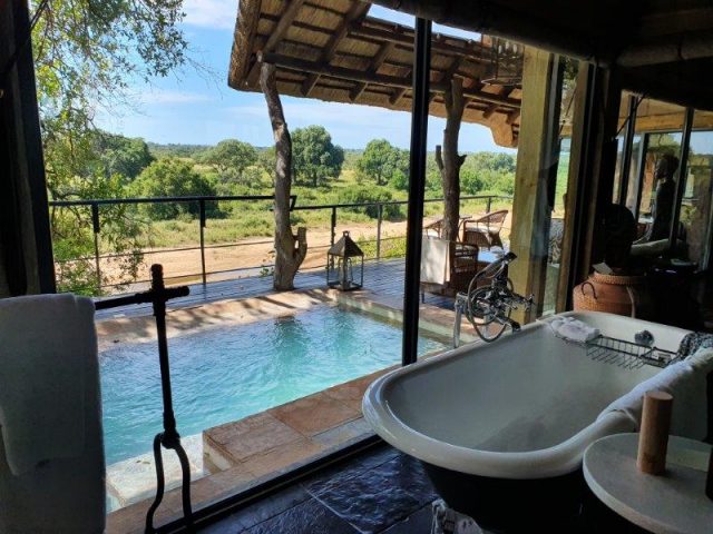 bath overlooking pool and riverbed Singita Ebony Lodge