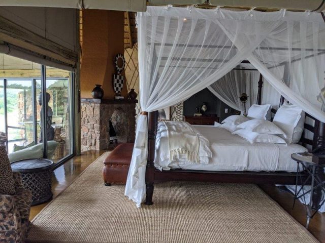 king bed and classic safari interior decorating in Singita Ebony Lodge room